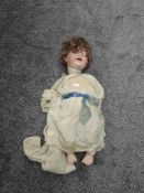 A early 20th century Alt, Beck & Gottschalck bisque headed doll having brown sleep eyes, open