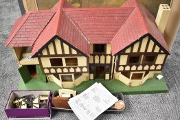 A 1930's Lines Triang wooden two storey Dolls House having two bedrooms, dinning room, hallway and