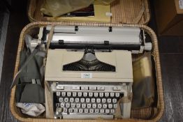 A vintage Hermes 3000 Typewriter in a suitcase, also included is a Singer Sewing hardback book.