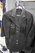 An unusual late 40s/50s black dress with asymmetric statement buttons, contrasting white accents and