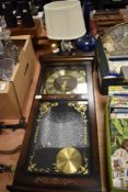 A President Quartz wall clock with pendulum and a modern glass bedside table lamp.