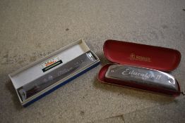 A vintage Hohner Educator II harmonica in original case and a Chinese Tower harmonica