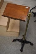 A Victorian music stand having mahogany stand with brass support and column on quadruple shaped cast