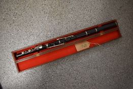 An antique wooden flute , stamped Soundy Bombay, in wooden case
