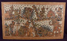 An Oriental polychrome Batik, mounted to board, depicting religious imagery, 49.5cm by 83.5cm.