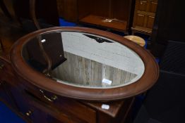 A mahogany frame oval wall mirror