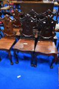 A beautiful set of six 19th Century mahogany hall chairs having solid seats and shield back , on