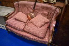 A French Louis XV style settee having carved and moulded show frame and patterned material