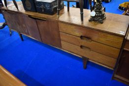 A mid century Teak long boy side board having three drawers and double cupboards in need of