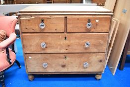 A Victorian rustic pine chest of two over two drawers with glass handles
