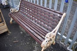 A traditional Coalbrookdale style cast iron bench with wooden slats