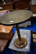 An Anglo Indian style circular brass table top on turned wooden column base (possibly marriage)