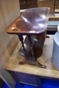 A reproduction mahogany occasional coffee table with trough storage under