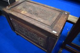 A composite oak bedding box having carved panels