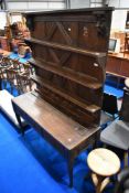 An interesting composite oak dresser having panelled delft rack over three drawer base