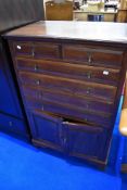 An early 20th Century mahogany cabinet having two over four drawers and cupboard to base, width