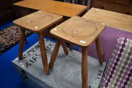 A pair of pine stools on splay legs