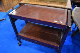 A vintage mahogany and rosewood effect metamorphic tea trolley