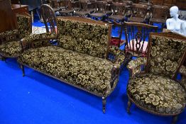 An Edwardian mahogany three piece suite with inlaid decoration and later velvour upholstery
