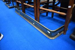 A pierced brass fire fender, width approx.133cm