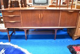 A vintage teak sideboard, having stylised handles and undershelf, width approx 183cm, , light wear
