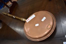 A traditional copper bed pan