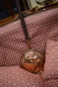 A traditional copper warming pan