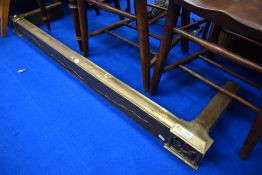 A traditional brass fire fender, width approx. 140cm