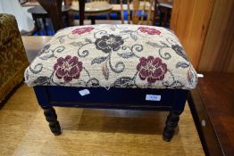 A reproduction footstool with storage