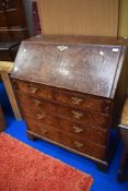 A Georgian Burr Walnut bureau having fitted interior beneath fall fap, with two over three drawer