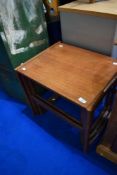 A vintage teak nest of three tables