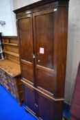 A Victorian mahogany panelled double height corner cupboard, approx. Height 215cm