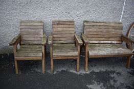 A stained wood garden bench and two similar chairs