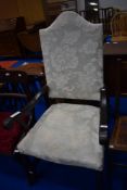 A traditional wood frame armchair having scroll arms and upholstered seat and back