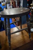 A traditional stool having oval top, turned legs and H stretcher