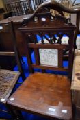 A Victorian hall chair having tile to back, with solid seat and turned legs