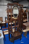 A late 19th or early 20th Century oak hall stand with seat storage