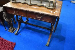 A reproduction side table having double frieze drawers, drop flaps and lyre ends