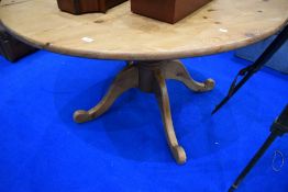 A large pine circular dining table on turned column and quadruple splay legs, diameter approx.