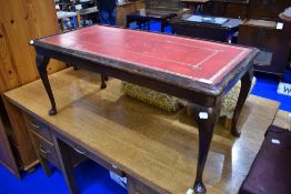 A reproduction skiver top coffee table