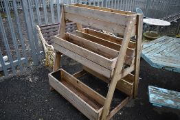 A three tier wooden planter trough, height approx. 130cm , width 105cm , depth 105cm