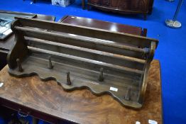 A vintage oak hall shelf with rail and coat hooks