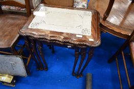 A reproduction nest of three mahogany tables