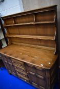 A traditional dark stained Ercol or similar kitchen dresser