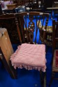A traditional stained frame wheelback kitchen chair
