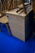 A beech effect laminate three drawer office/filing cabinet