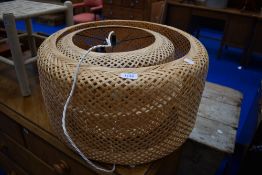 A modern light fitting with woven shade