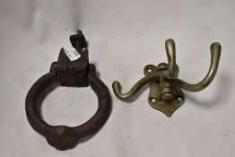 A Victorian Cast iron door knocker missing its back plate with a brass swivel hook.