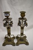 A pair of colonial styled brass candlesticks having copper worked flower and tree branch design.