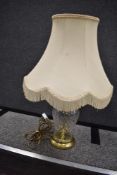A vintage clear cut crystal lamp base with brass fitments.